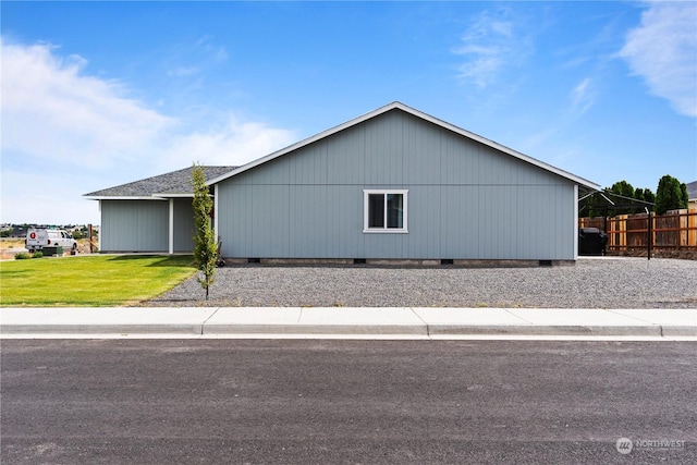 view of side of property with a yard