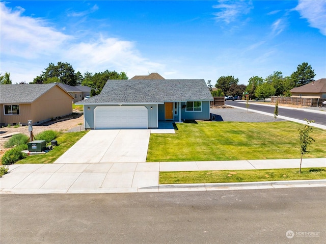 view of front of property featuring a garage and a front lawn