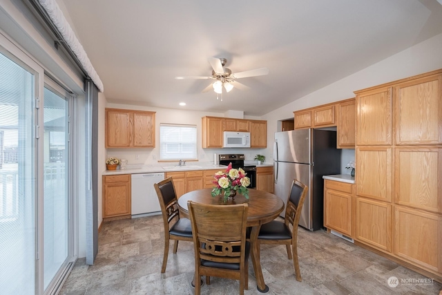 kitchen with sink, vaulted ceiling, ceiling fan, and appliances with stainless steel finishes