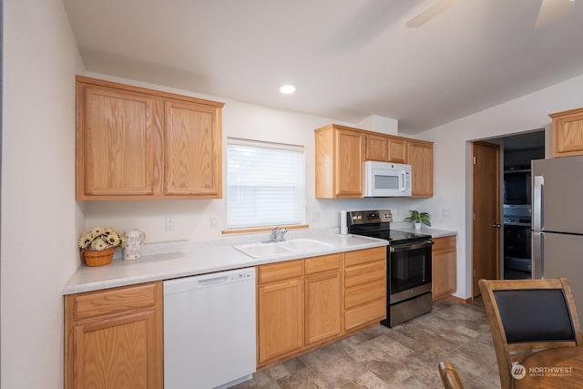 kitchen featuring light brown cabinetry, sink, and stainless steel appliances