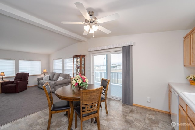 carpeted dining room featuring lofted ceiling with beams and ceiling fan