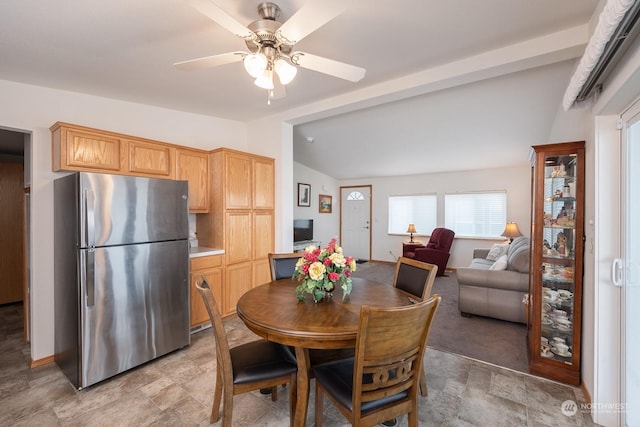 dining area featuring ceiling fan and lofted ceiling