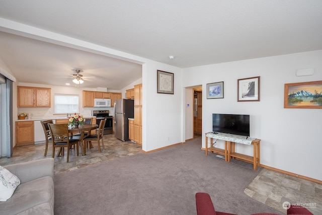 carpeted living room with vaulted ceiling and ceiling fan