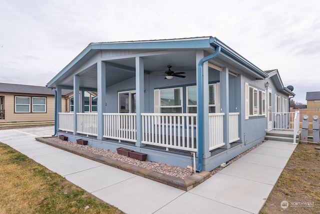 view of side of property featuring a porch and ceiling fan