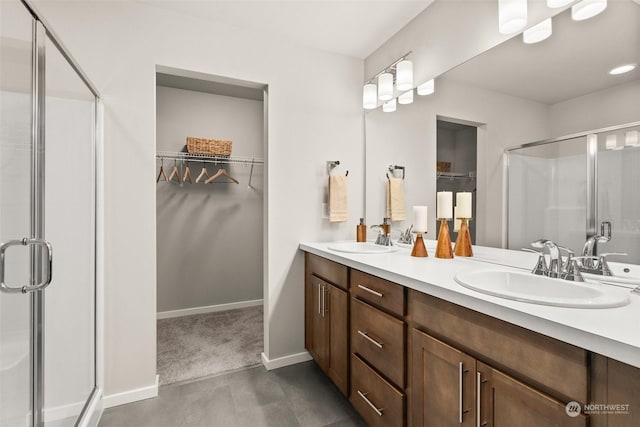 bathroom featuring a shower with door and vanity