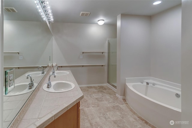 bathroom featuring vanity and shower with separate bathtub