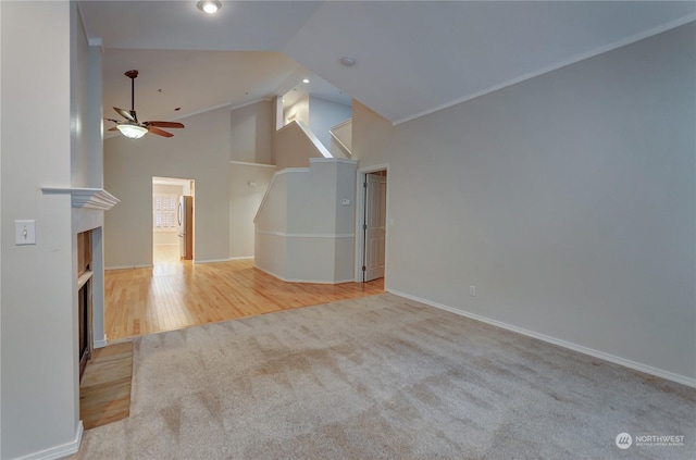 unfurnished living room featuring high vaulted ceiling, light hardwood / wood-style floors, and ceiling fan