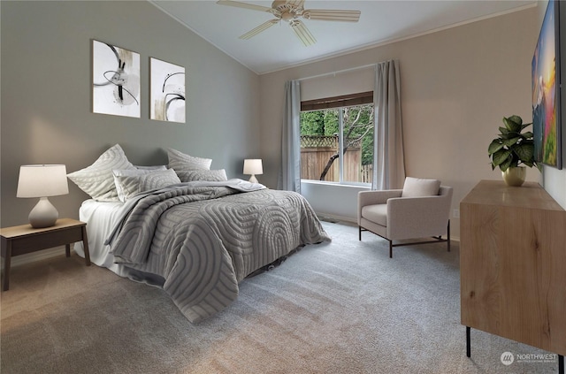 bedroom featuring ceiling fan, ornamental molding, vaulted ceiling, and light carpet