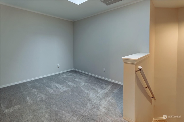 spare room with ornamental molding and carpet floors