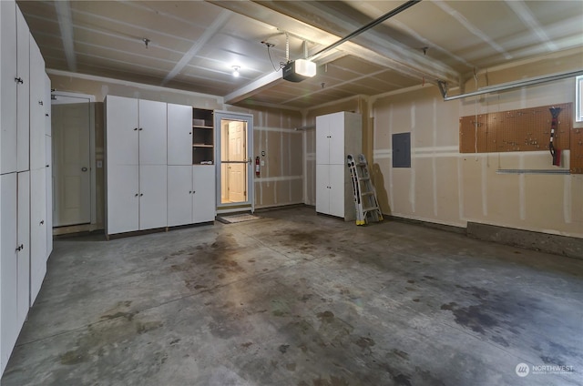 garage featuring a garage door opener and electric panel