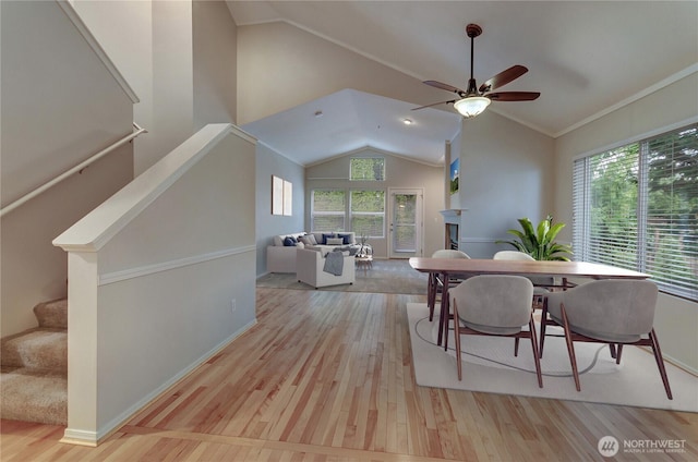 dining space featuring high vaulted ceiling, light hardwood / wood-style floors, and ceiling fan