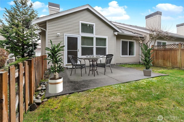 back of property featuring a yard and a patio area