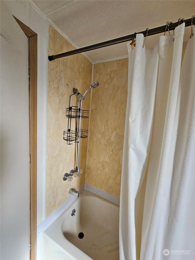 bathroom with shower / tub combo with curtain, crown molding, and a textured ceiling