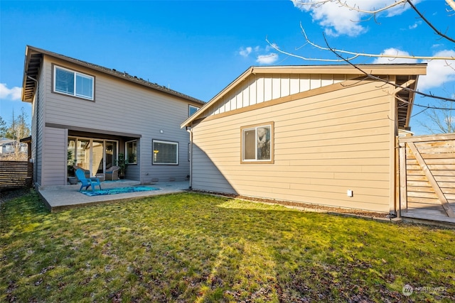 rear view of house with a patio area and a lawn