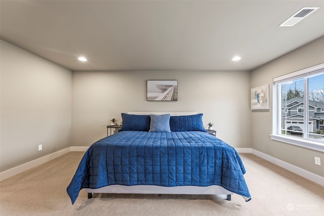 bedroom featuring light colored carpet