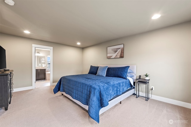 carpeted bedroom featuring ensuite bathroom