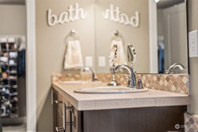 bathroom with tasteful backsplash and vanity