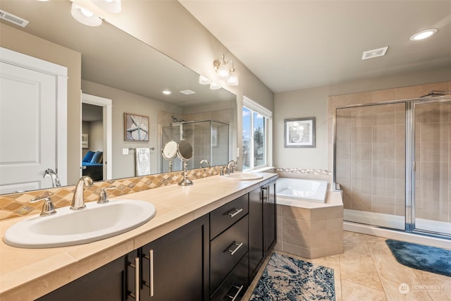 bathroom with tasteful backsplash, shower with separate bathtub, tile patterned flooring, and vanity