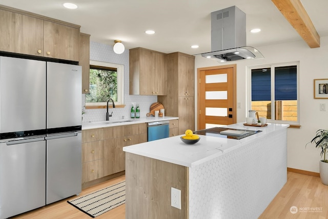 kitchen featuring a center island, island exhaust hood, light countertops, stainless steel appliances, and a sink