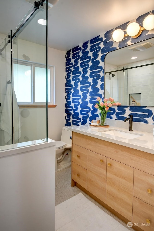 full bathroom with toilet, a shower stall, visible vents, and vanity