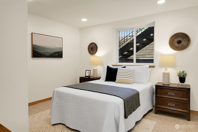 bedroom featuring light carpet, recessed lighting, and baseboards