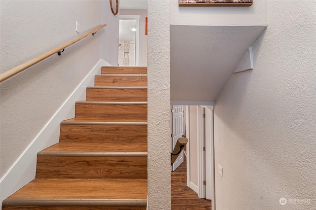 stairs featuring hardwood / wood-style flooring