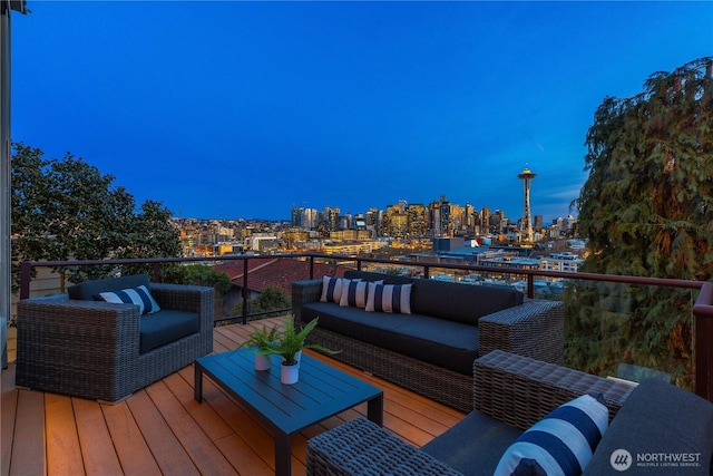 deck at dusk featuring an outdoor hangout area