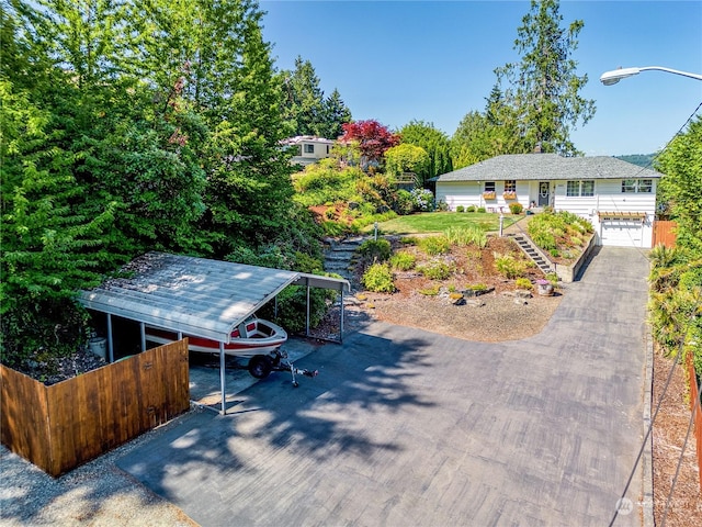 ranch-style home with a carport, driveway, and an attached garage