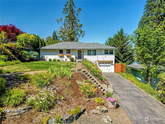 ranch-style home with driveway, an attached garage, stairs, and a front yard