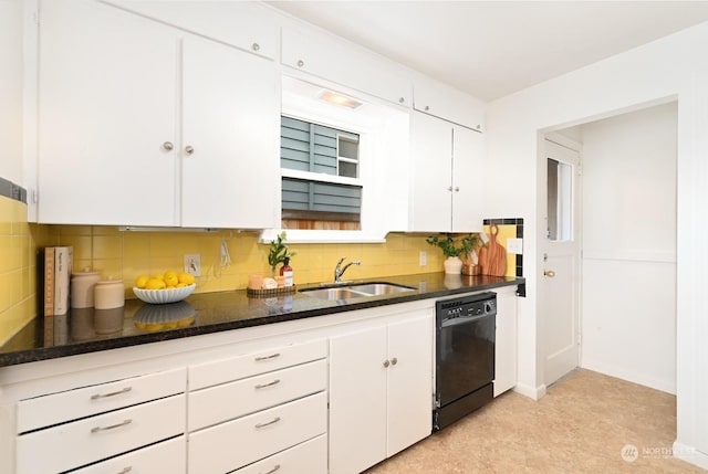 kitchen featuring sink, tasteful backsplash, dark stone countertops, black dishwasher, and white cabinets