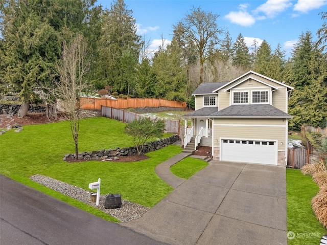 view of property featuring a garage and a front yard