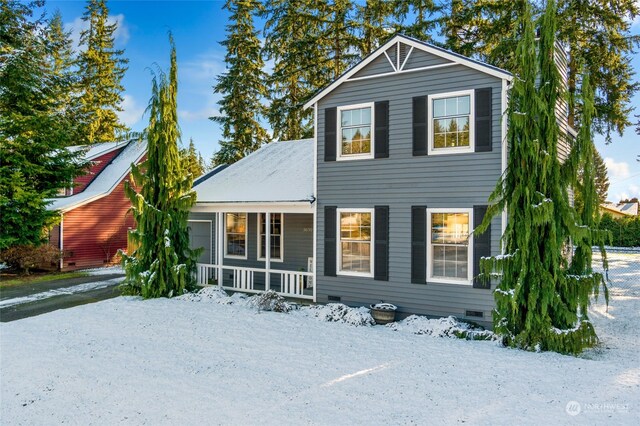 snow covered house with a porch