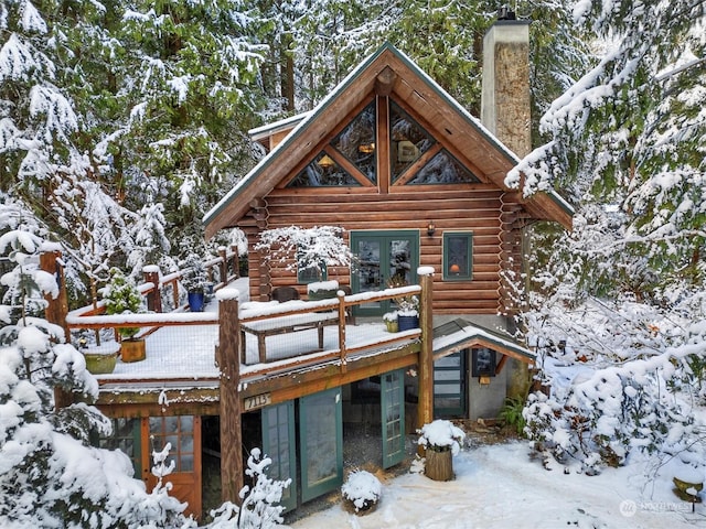 view of snow covered back of property