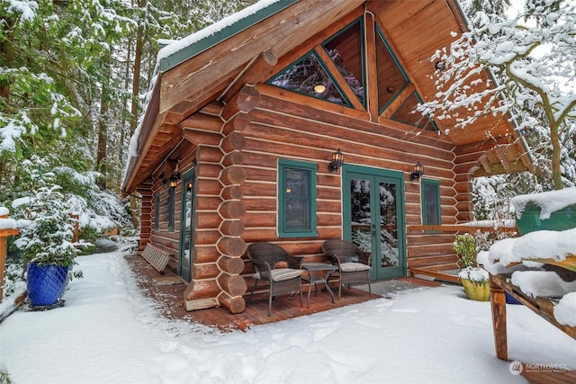 view of snow covered exterior featuring french doors