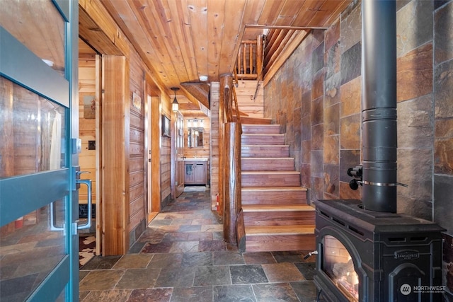 hallway with wood ceiling and wood walls