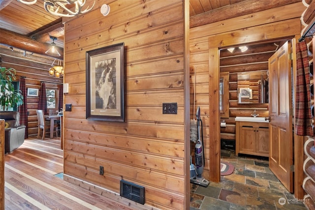 hallway featuring wooden ceiling and beamed ceiling