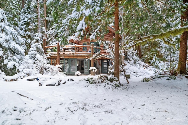 view of snowy exterior with a deck