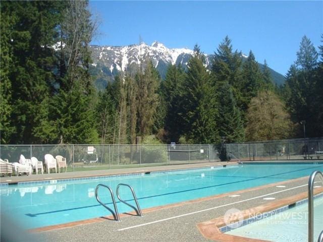 view of swimming pool featuring a mountain view