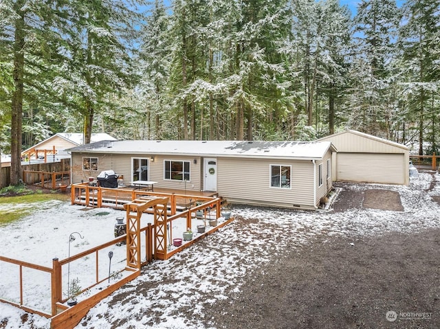 view of front of property with a garage and a deck