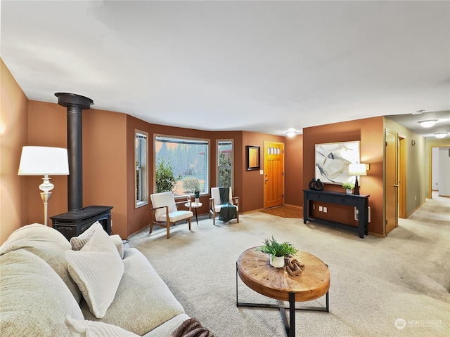 living room with a wood stove and light carpet