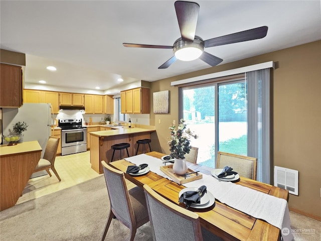 dining room with sink and light carpet