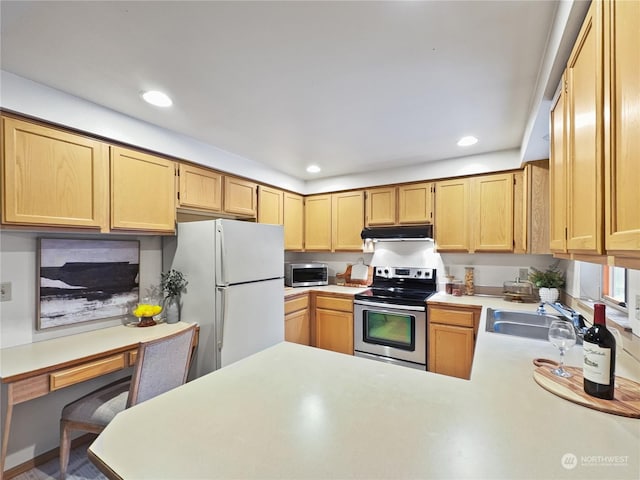 kitchen featuring appliances with stainless steel finishes, sink, light brown cabinetry, and kitchen peninsula