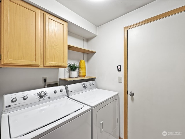 laundry room with cabinets and washing machine and clothes dryer