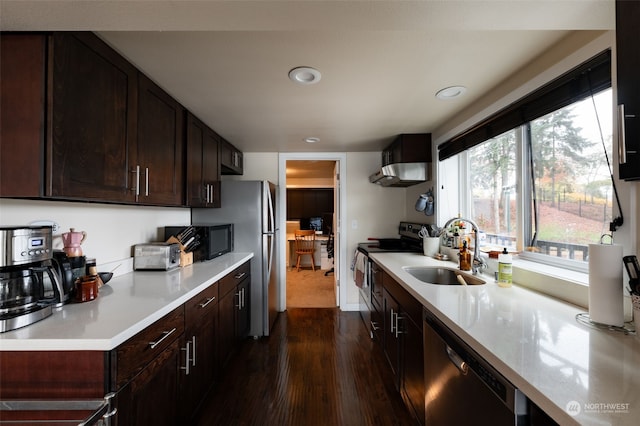 kitchen with dark brown cabinetry, sink, dark hardwood / wood-style flooring, and black appliances