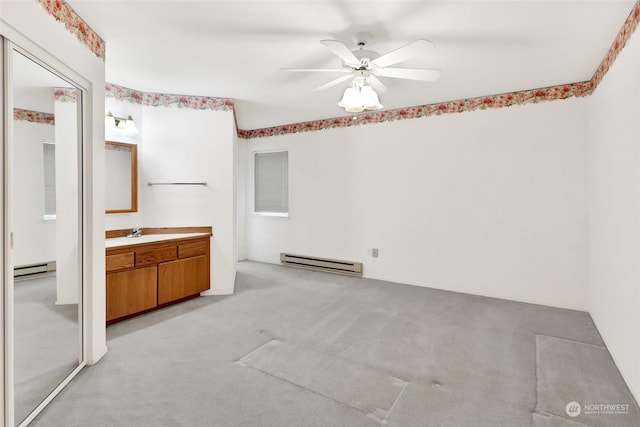 bathroom with a baseboard heating unit, vanity, baseboard heating, and a ceiling fan