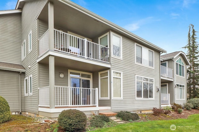 back of property featuring covered porch