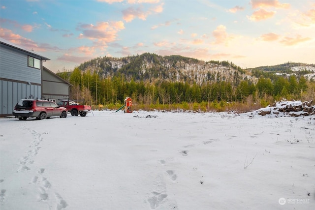 snowy yard with a mountain view