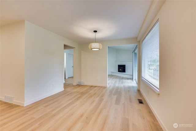 interior space with a fireplace and light wood-type flooring