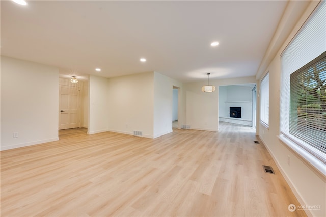 unfurnished living room with light wood-type flooring