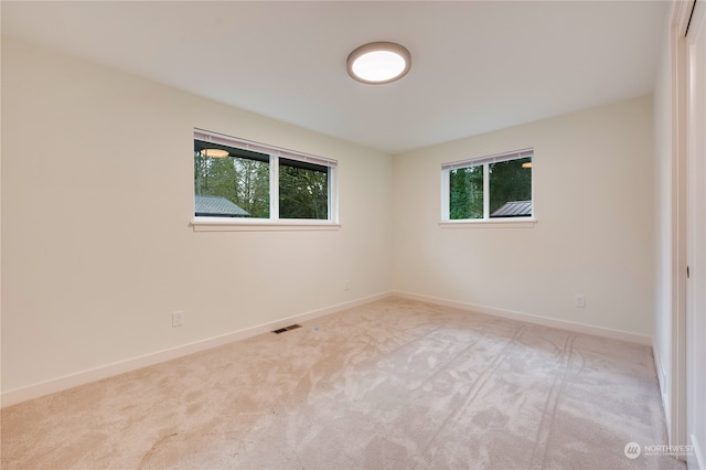 empty room featuring light carpet